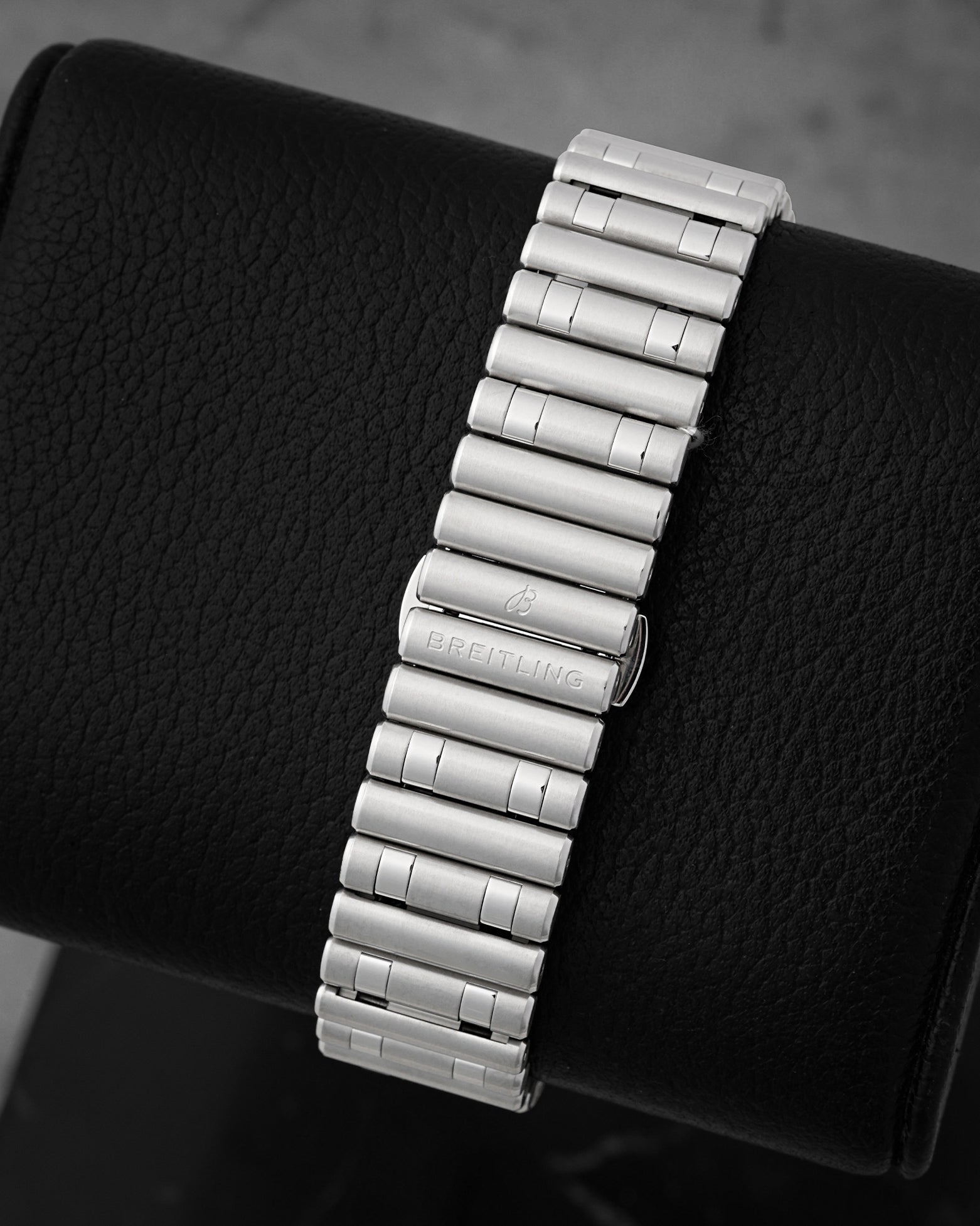 A rear view of the iconic stainless steel Rouleaux bracelet focusing on the uniform cylindrical bullet-shaped links and the clean hidden butterfly deployment clasp interface