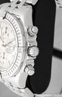 Close-up side view of the screw-down crown, chronograph pushers, and rider tab bezel on Breitling Chronomat Evolution A13356