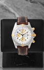 Preowned two-tone Breitling Chronomat Evolution B13356 silver dial watch at Noah's Fine Watches & Jewelry in Dallas, TX