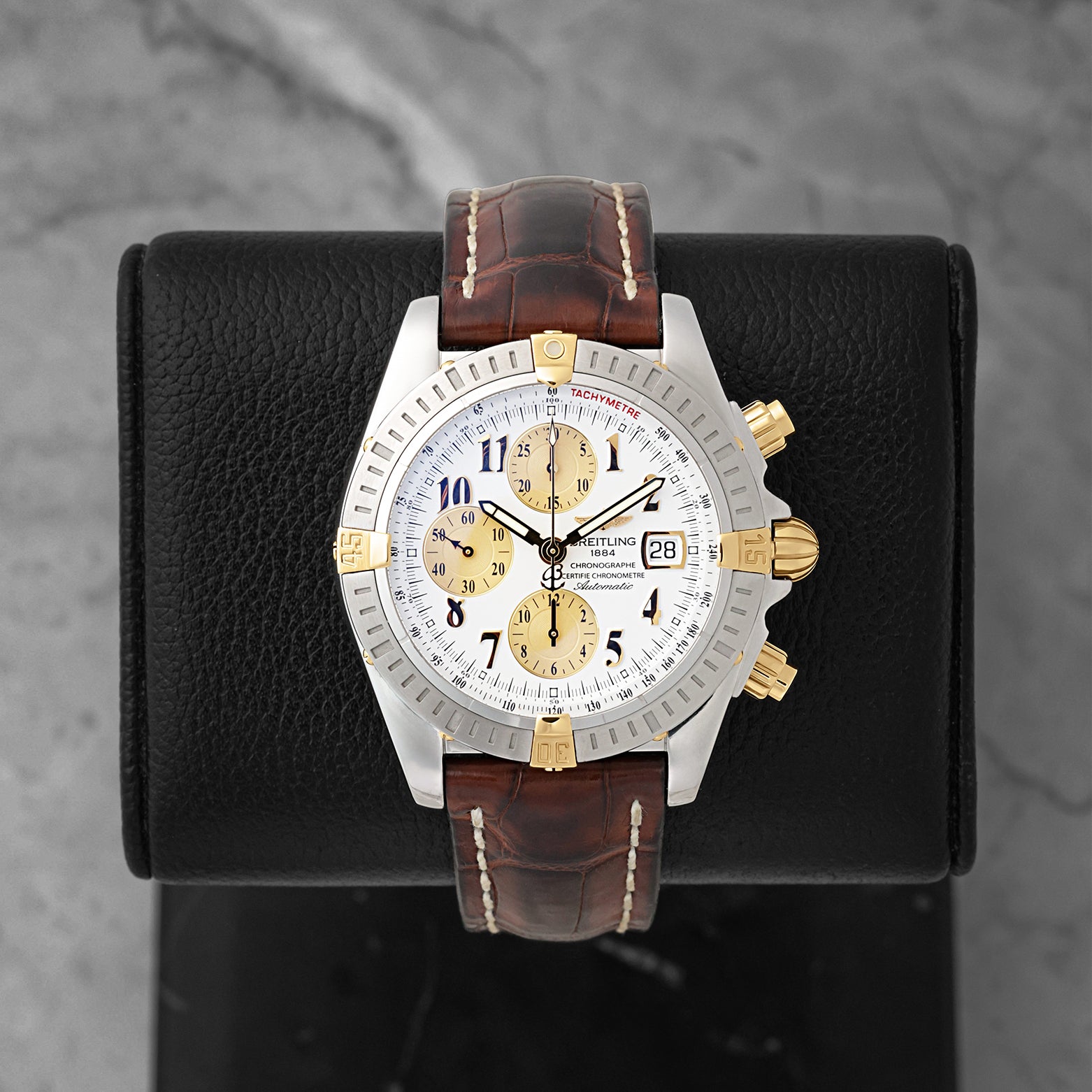 Preowned two-tone Breitling Chronomat Evolution B13356 silver dial watch at Noah's Fine Watches & Jewelry in Dallas, TX