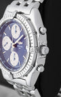 Right side profile view highlighting the signature onion crown, chronograph pushers, and unidirectional rotating bezel with rider tabs on a Breitling Chronomat A13050