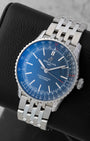 Angled front view of a preowned Breitling Navitimer Automatic 41 A17329 featuring a blue dial, red-tipped central seconds hand, and bidirectional slide rule bezel