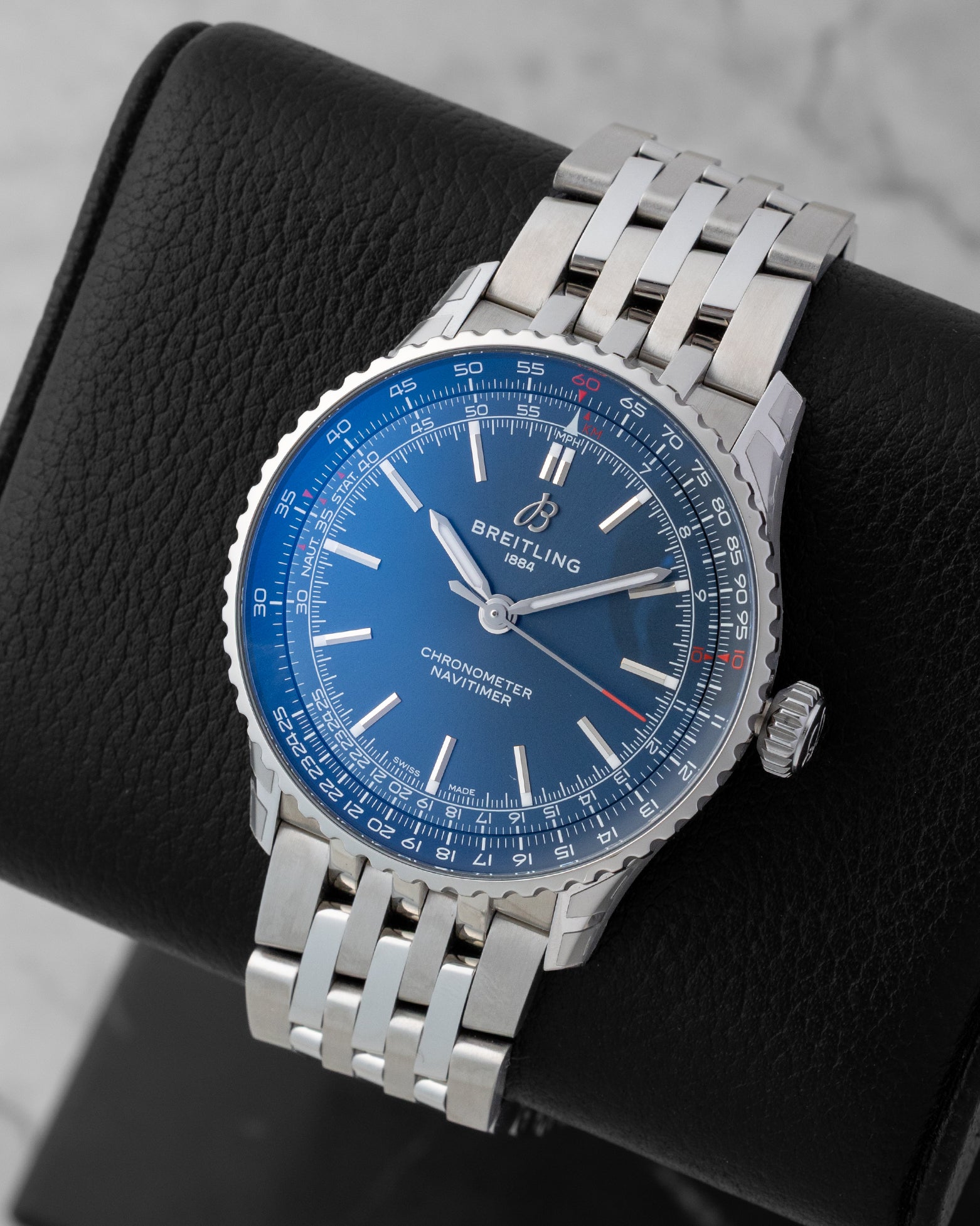 Angled front view of a preowned Breitling Navitimer Automatic 41 A17329 featuring a blue dial, red-tipped central seconds hand, and bidirectional slide rule bezel