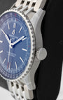 Side profile detail showing the 41mm stainless steel case, beaded slide rule bezel edge, and signed winding crown on a Breitling Navitimer A17329