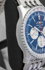 Side profile view of the polished and brushed stainless steel case on the non-crown side of a Breitling Navitimer 46