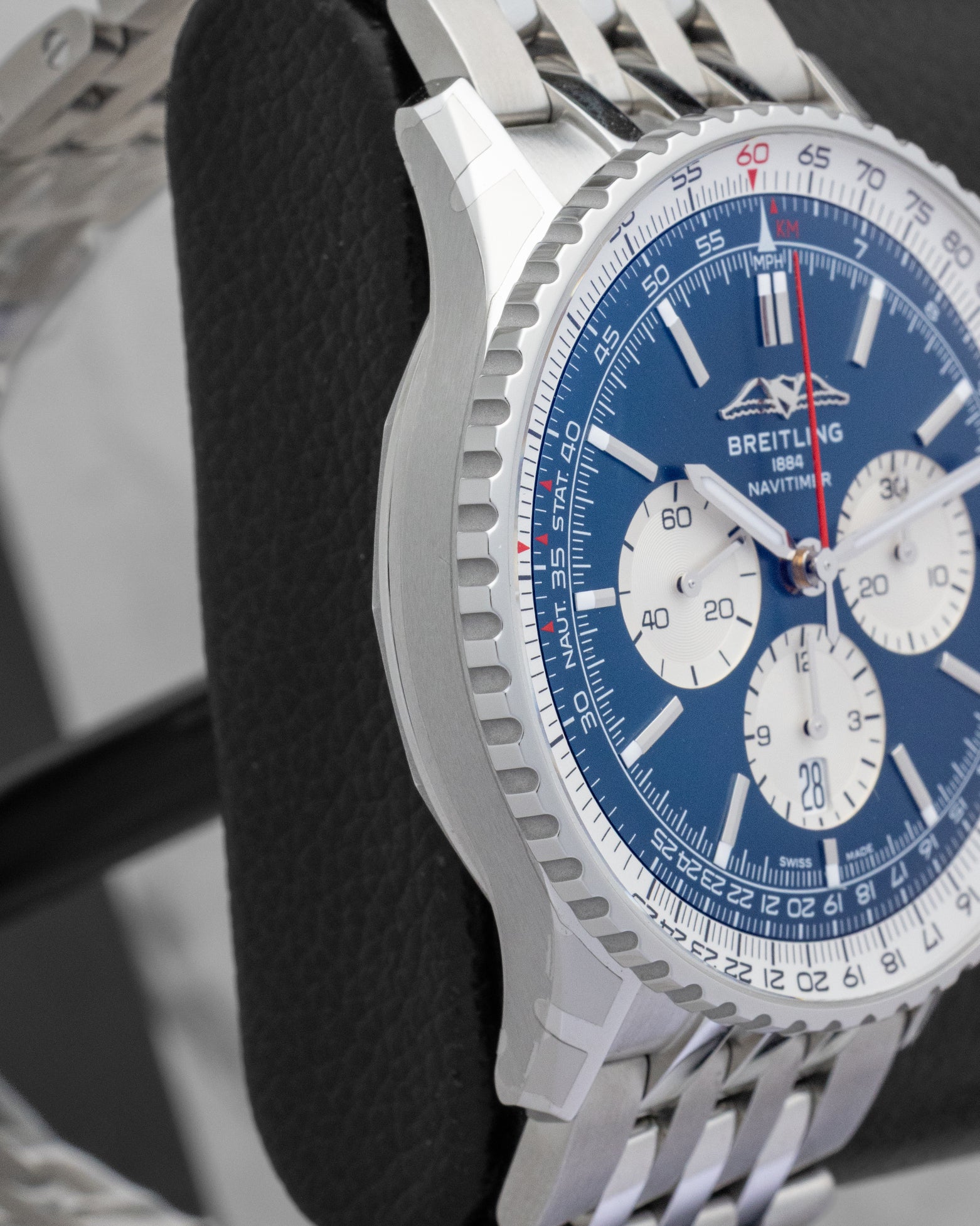Side profile view of the polished and brushed stainless steel case on the non-crown side of a Breitling Navitimer 46