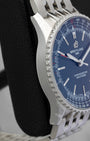 Left side profile view highlighting the polished and satin-brushed stainless steel case wall on a preowned Breitling Navitimer Automatic reference A17329