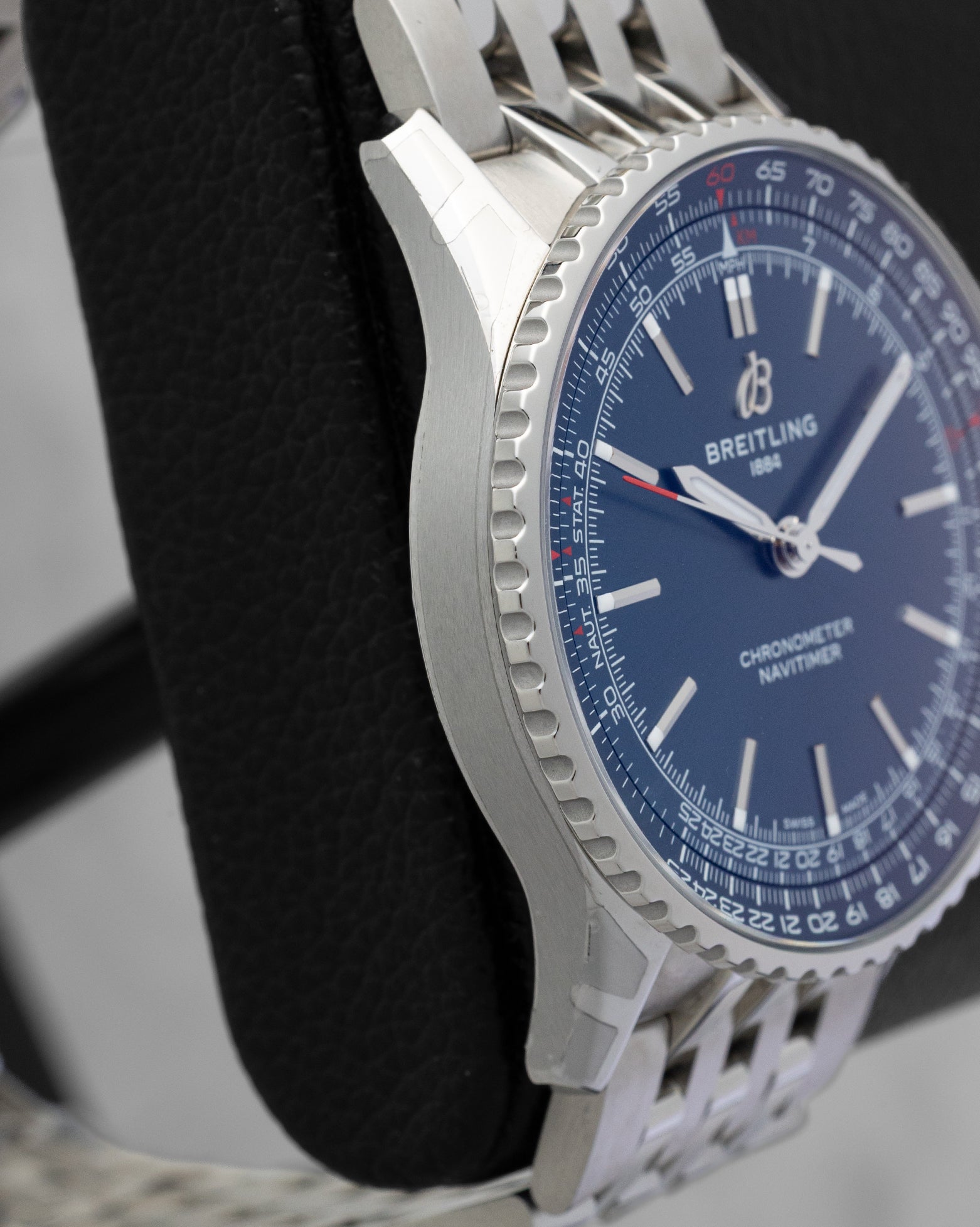Left side profile view highlighting the polished and satin-brushed stainless steel case wall on a preowned Breitling Navitimer Automatic reference A17329