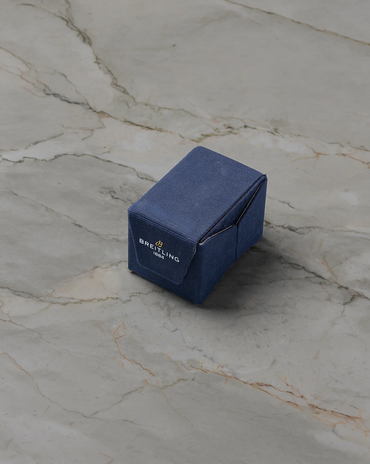 Official blue eco-friendly folding presentation watch box included with pre-owned Breitling Navitimer B01 AB0138 at Noah's Fine Watches & Jewelry in Dallas