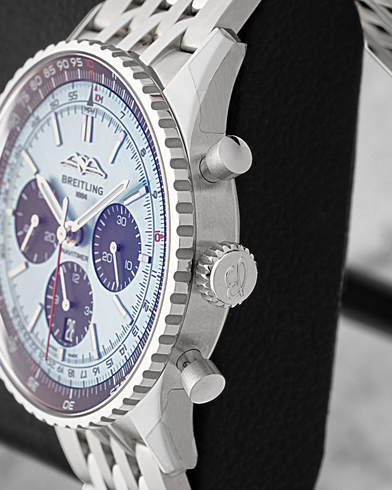 Side profile view showing the stainless steel case, piston-style chronograph pushers, and non-screw-down winding crown on Breitling Navitimer B01 AB0138