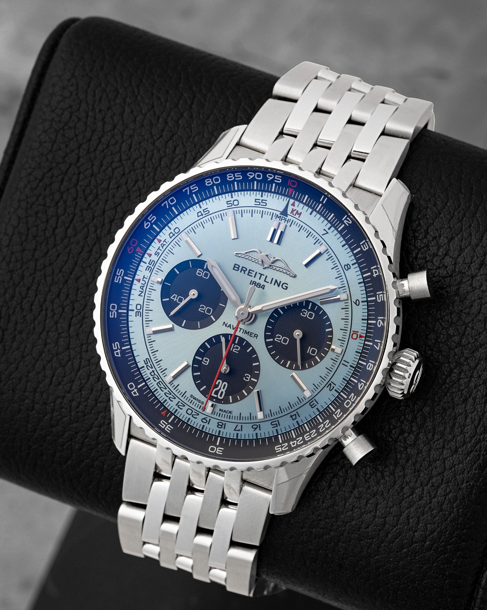 Angled front view of pre-owned Breitling Navitimer B01 AB0138 featuring an ice blue dial, AOPA wings logo, black chronograph counters, and bi-directional slide rule bezel