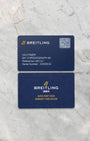 The official modern Breitling QR code smart warranty card and electronic documentation kit displayed on a marble background