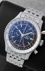 Angled front view of a preowned Breitling Navitimer World GMT A24322 featuring a black chronograph dial, red GMT hand, and bidirectional slide rule bezel
