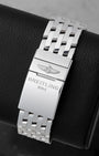Back view showing the stainless steel Navitimer bracelet with folding clasp engraved with the Breitling 1884 logo
