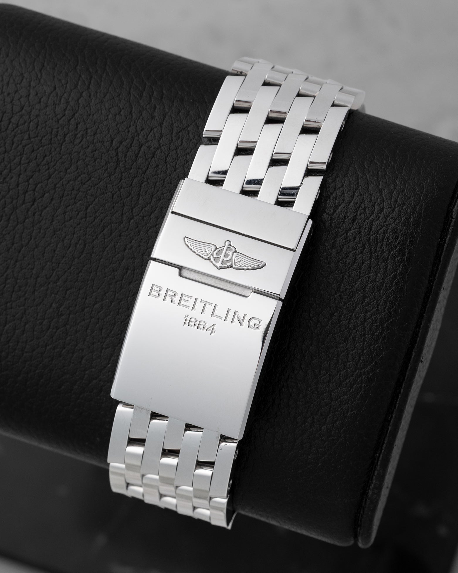 Back view showing the stainless steel Navitimer bracelet with folding clasp engraved with the Breitling 1884 logo