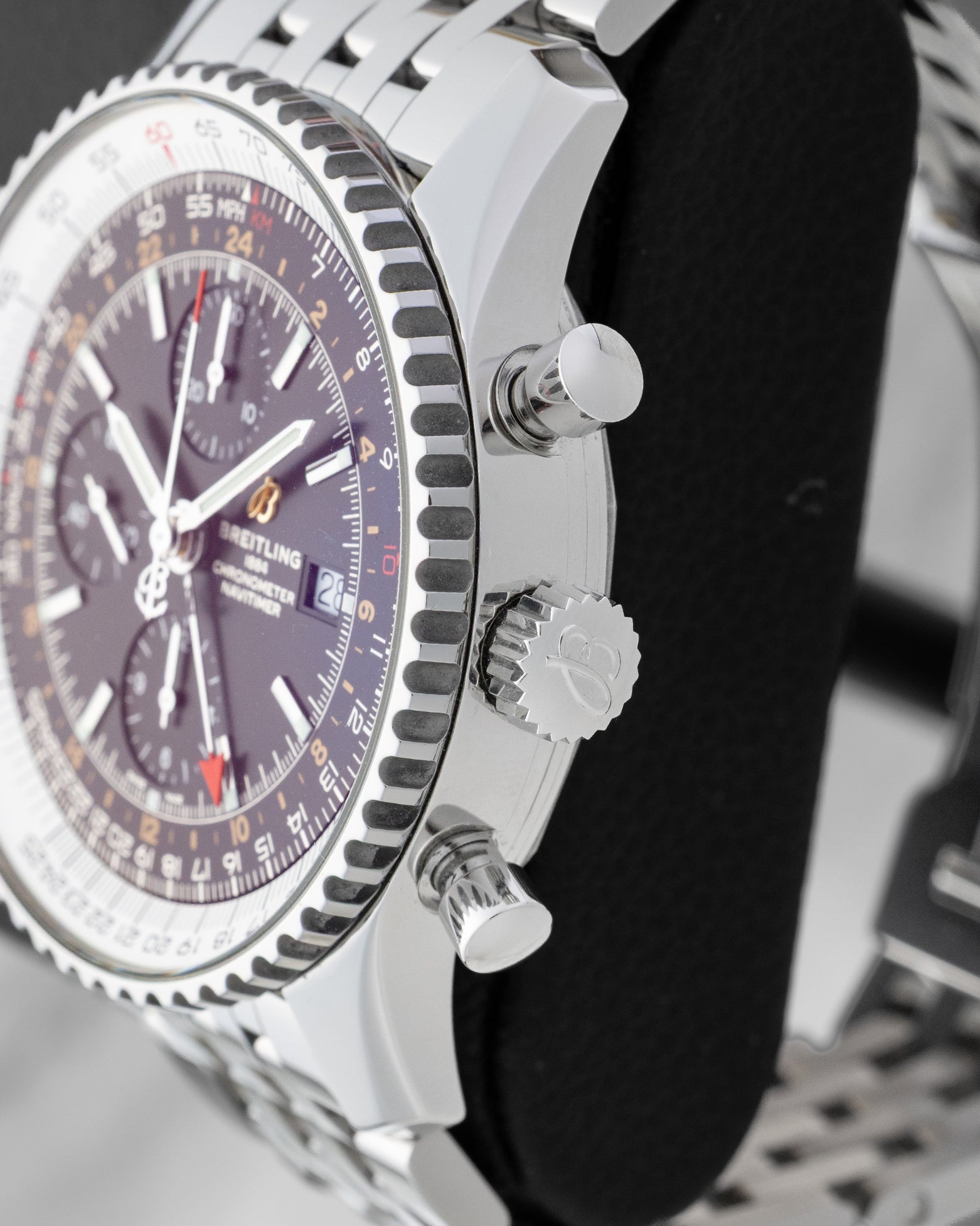 Side profile showing the 46mm stainless steel case, signed winding crown, and chronograph pushers on a Breitling Navitimer World A24322