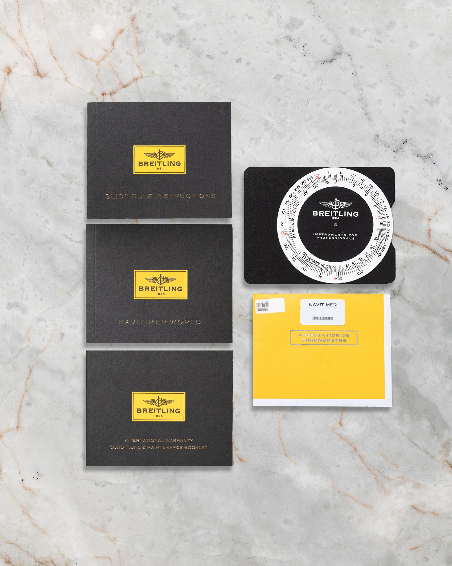 Breitling Navitimer World reference A2432212 documentation, slide rule user guide, COSC certificate, and original booklets