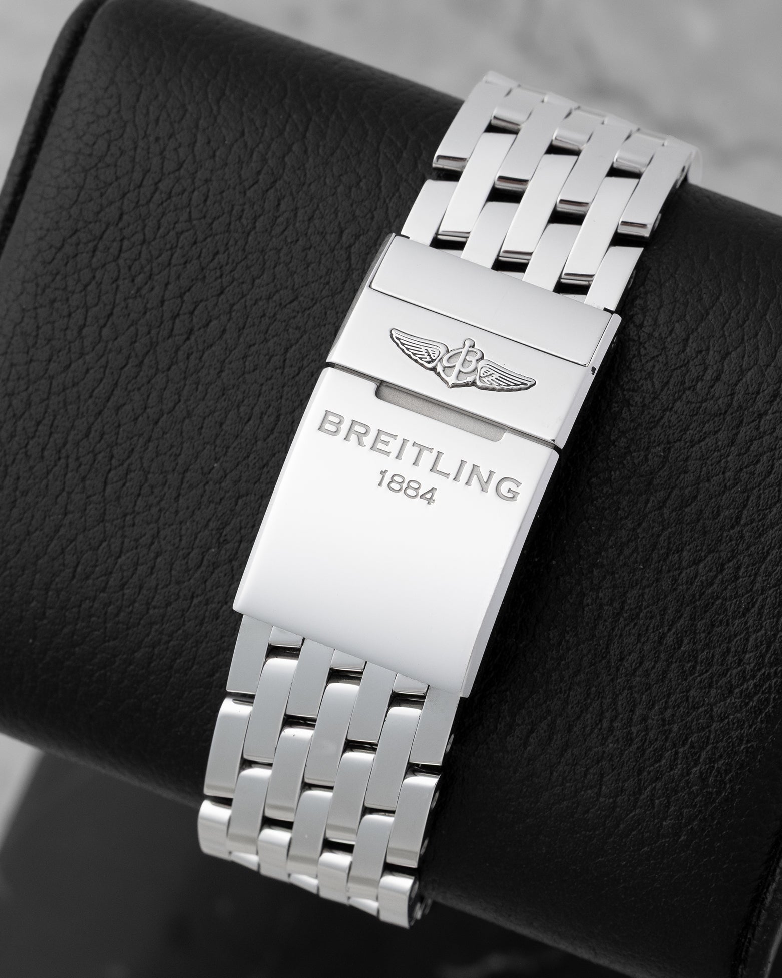 Back view showing the stainless steel Navitimer bracelet with folding clasp engraved with the Breitling 1884 logo