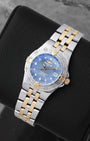 angled profile view of a ladies two-tone Breitling Starliner reference B71340 showcasing the textured blue Mother of Pearl dial and gold rider tabs