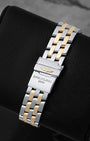 Rear view of the five-row two-tone steel and 18k yellow gold Pilot bracelet showing the folding deployment clasp with safety lever stamped with the Breitling wings anchor logo