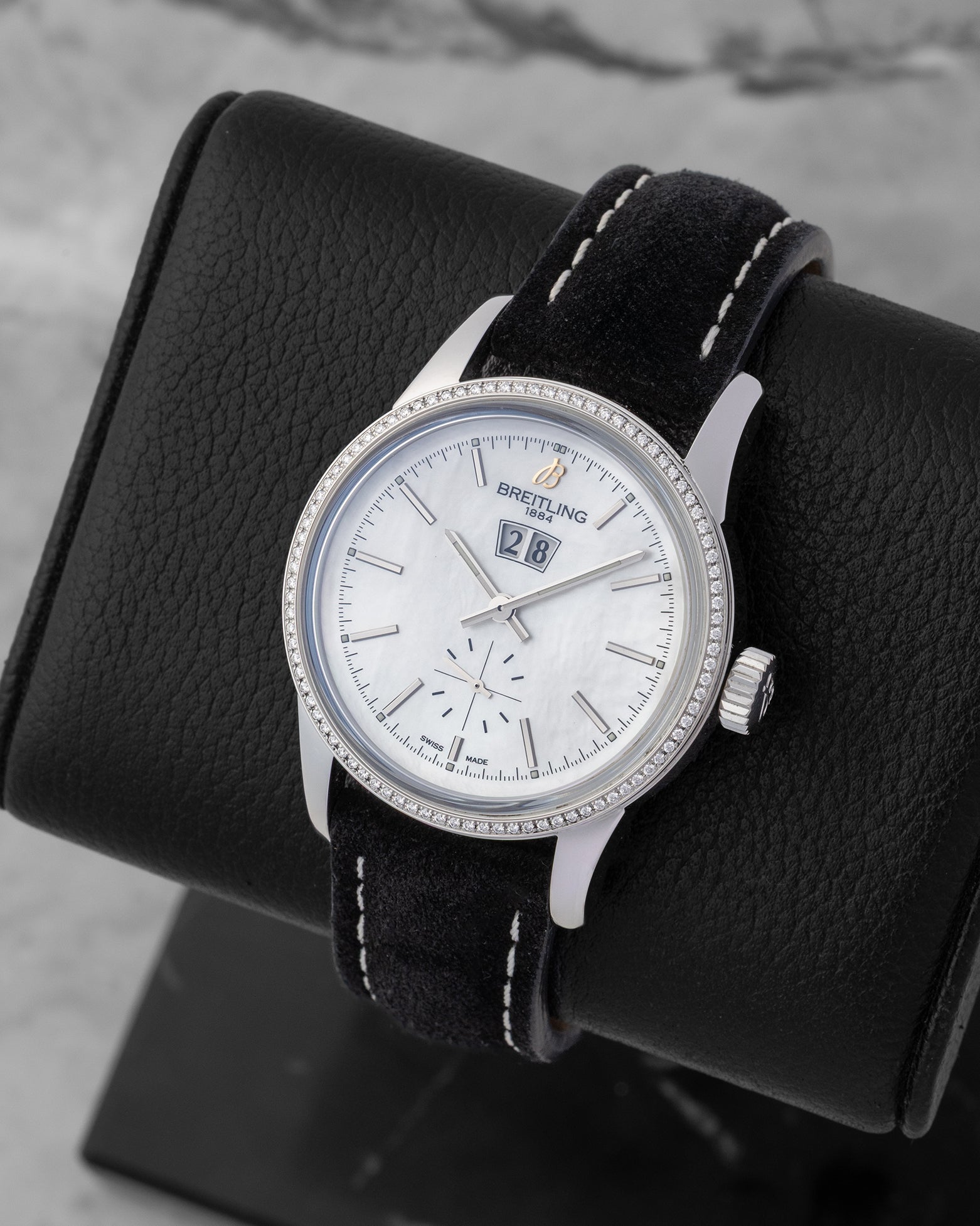 Angled collector view of a 38mm Breitling Transocean automatic watch showcasing its elegant small seconds sub-dial at 6 o'clock and black contrast-stitched leather strap