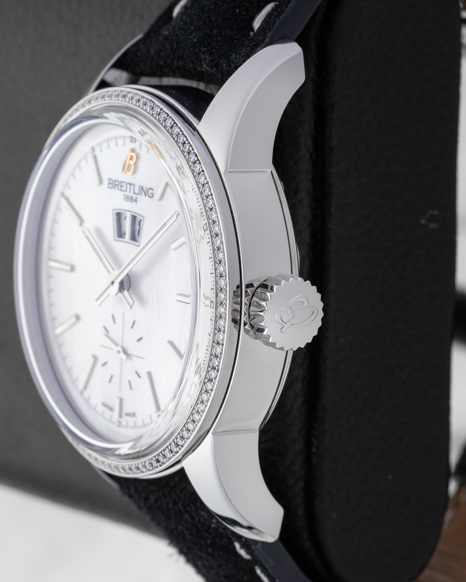 Macro case profile showing the intricate textured beaded bezel edge and signature fluted winding crown on a steel Breitling Transocean 38