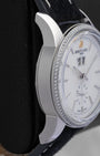 Polished left side profile of the 38mm stainless steel case on a classic Breitling Transocean chronometer watch resting on a leather display cushion