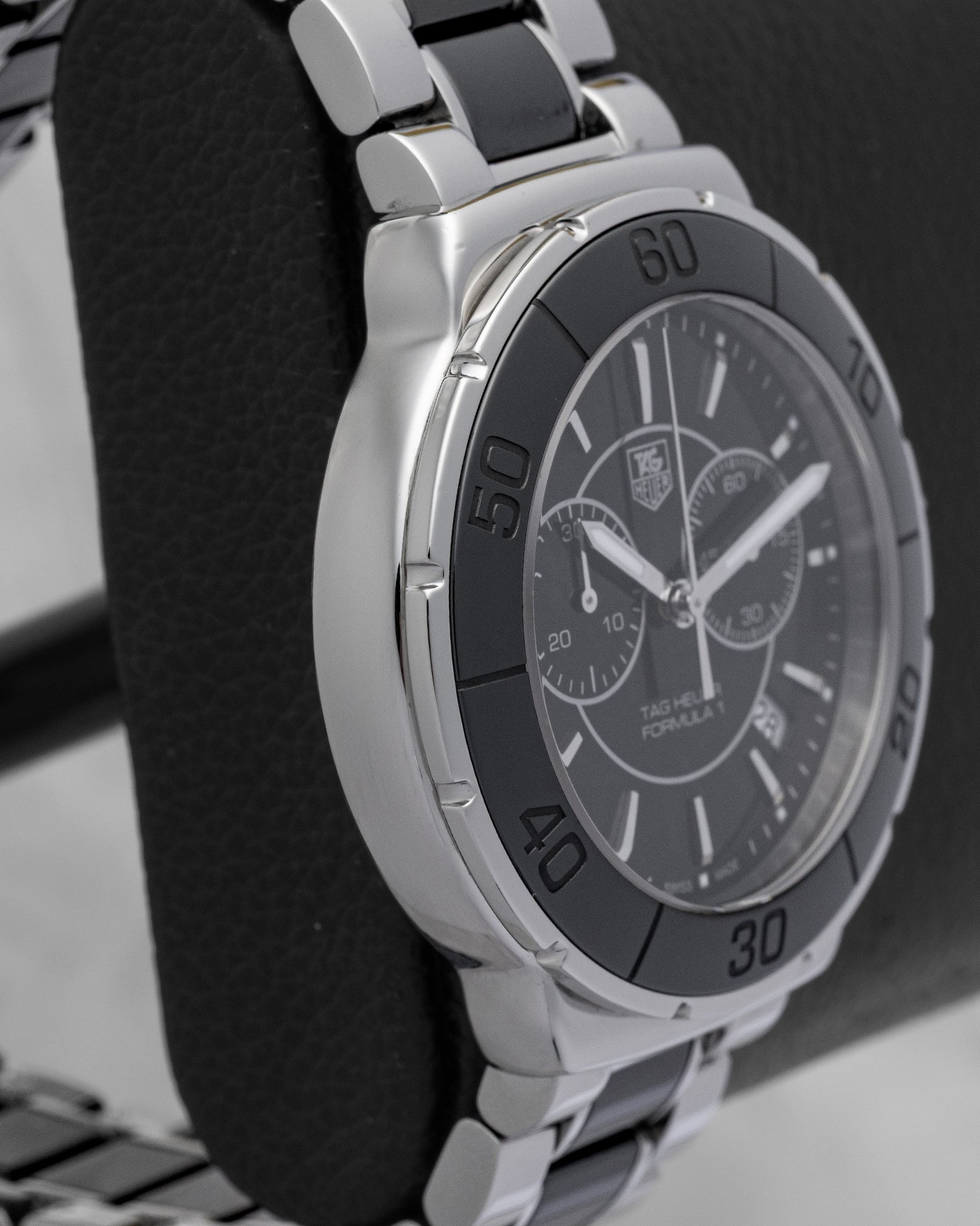 left side profile of the 41mm curves on a TAG Heuer Formula 1 case resting on a leather presentation block