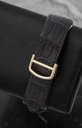 Dark purple alligator leather strap paired with a 18k yellow gold folding deployment buckle on a Cartier watch