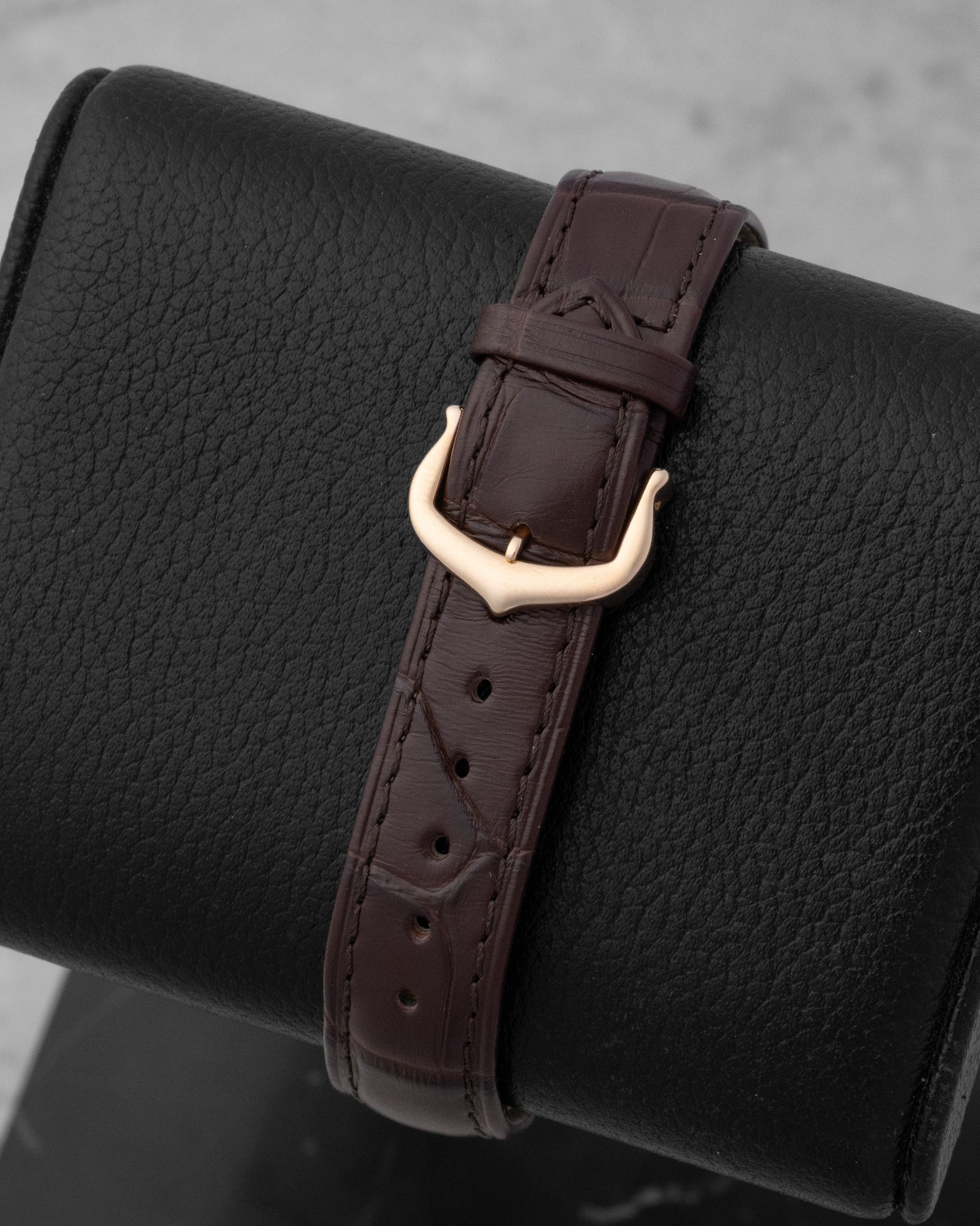 brown alligator leather strap secured by a solid 18k rose gold stylized Ardillon pin buckle on a Cartier watch