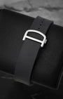 Rear perspective of the black rubber strap secured by a steel folding deployant buckle, highlighting Cartier's QuickSwitch interchangeable system