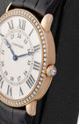 Close-up side profile of the rose gold Cartier case with circular-grained crown set with an inverted diamond