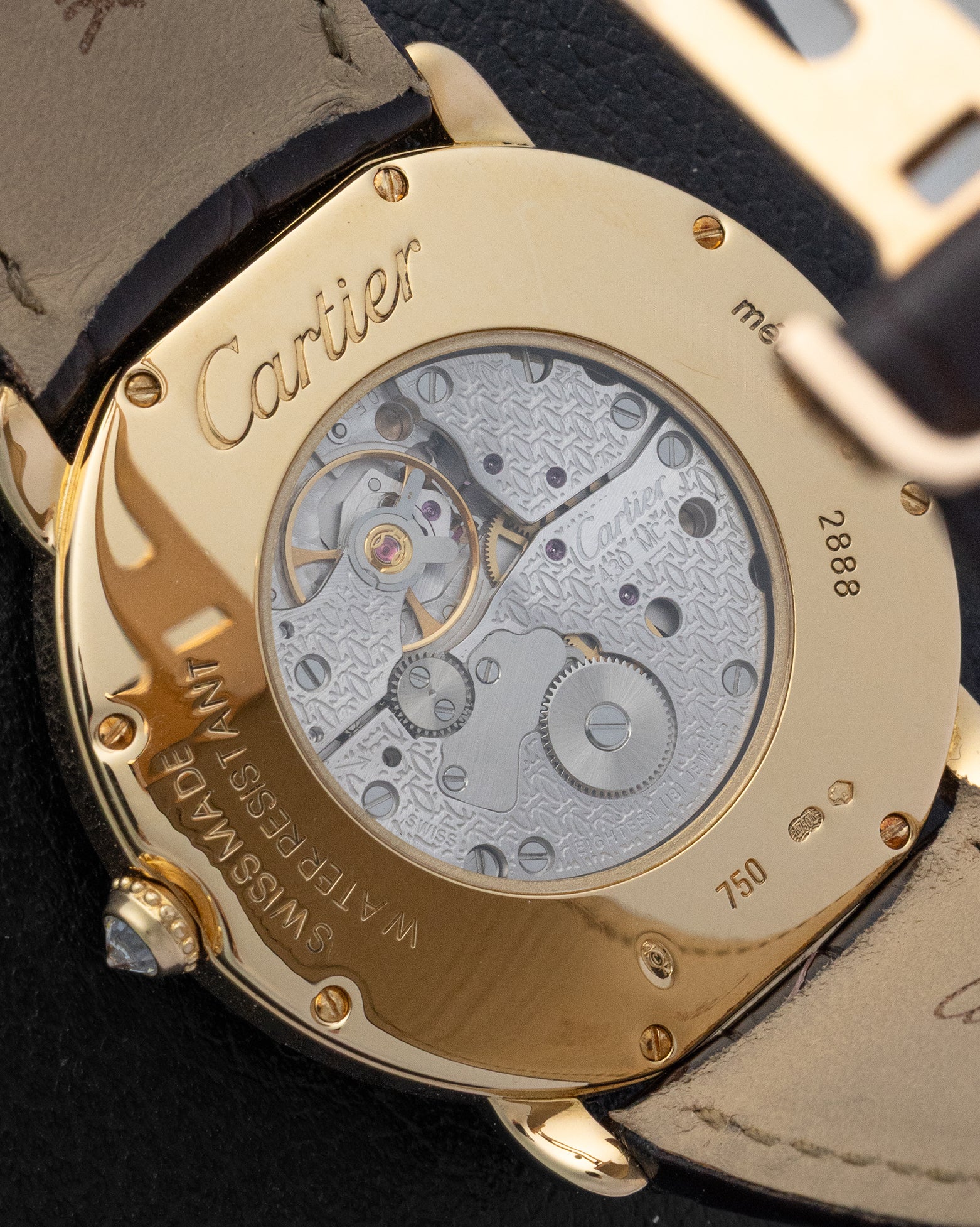 The clear sapphire exhibition caseback of a Cartier dress watch revealing the manual-winding calibre 430 MC mechanical movement