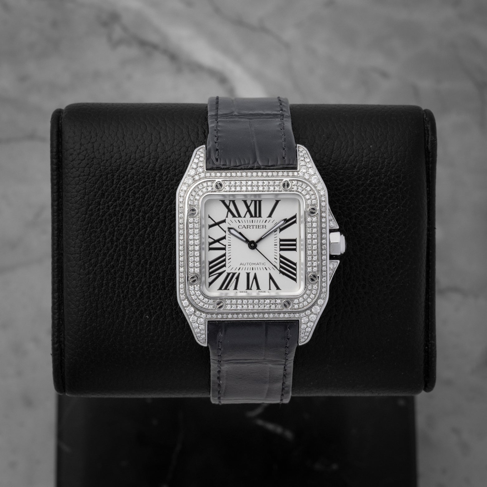 Cartier Santos 100 Medium watch featuring a custom diamond-set pave case diamond bezel and classic silver Roman numeral dial