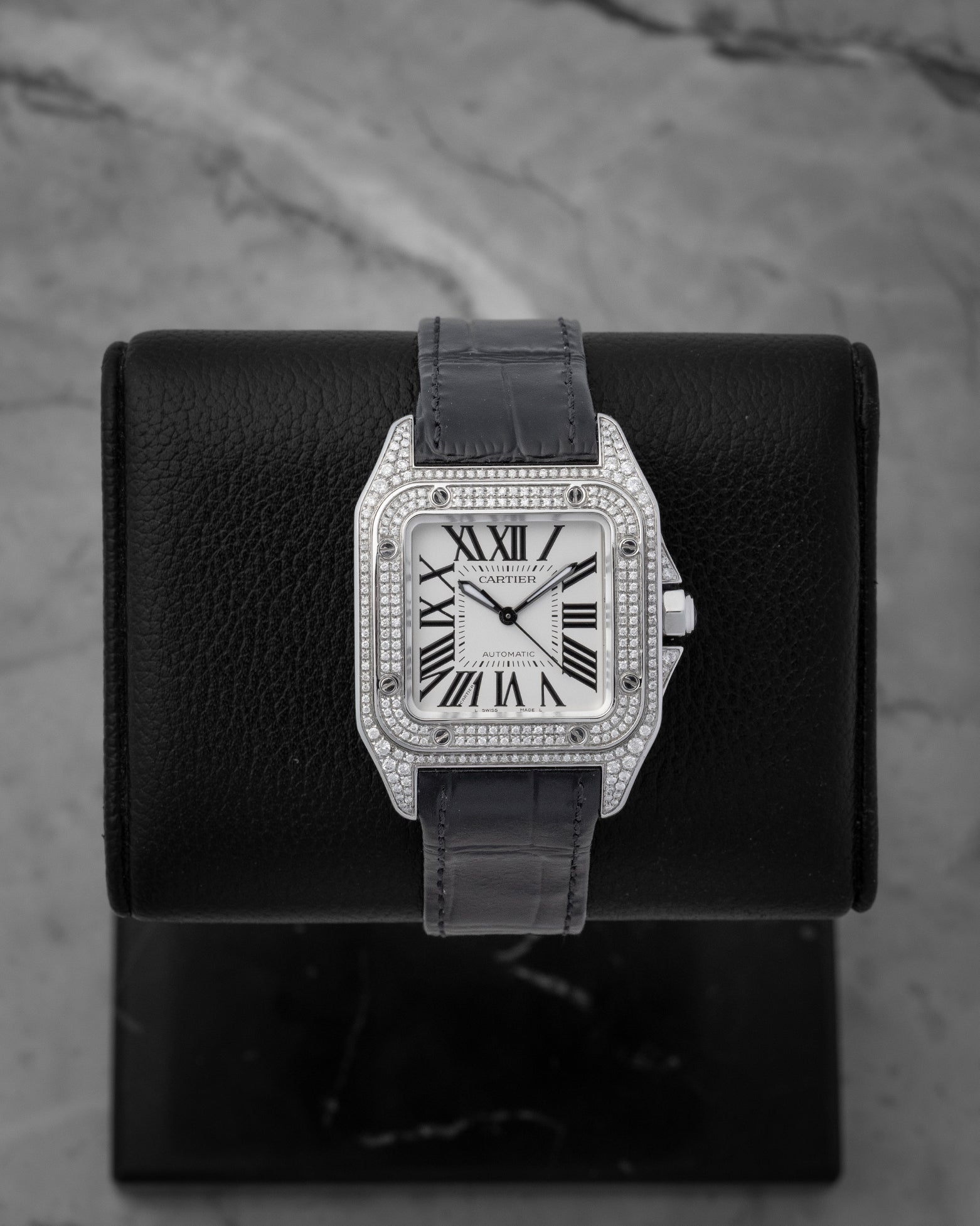 Cartier Santos 100 Medium watch featuring a custom diamond-set pave case diamond bezel and classic silver Roman numeral dial