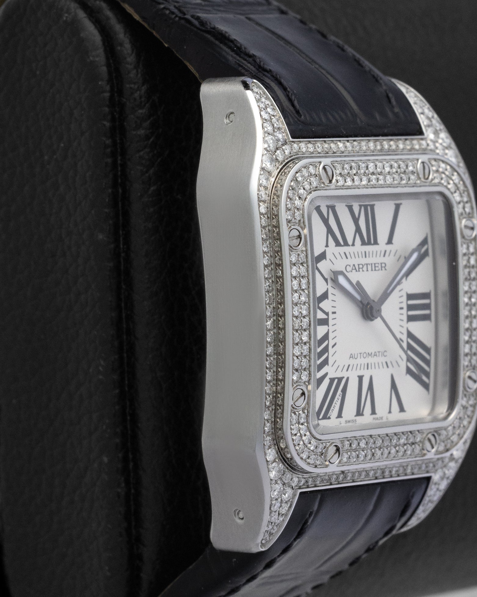 Left side profile view of the square robust pave diamond-set case on a mid-size Cartier Santos 100 automatic watch