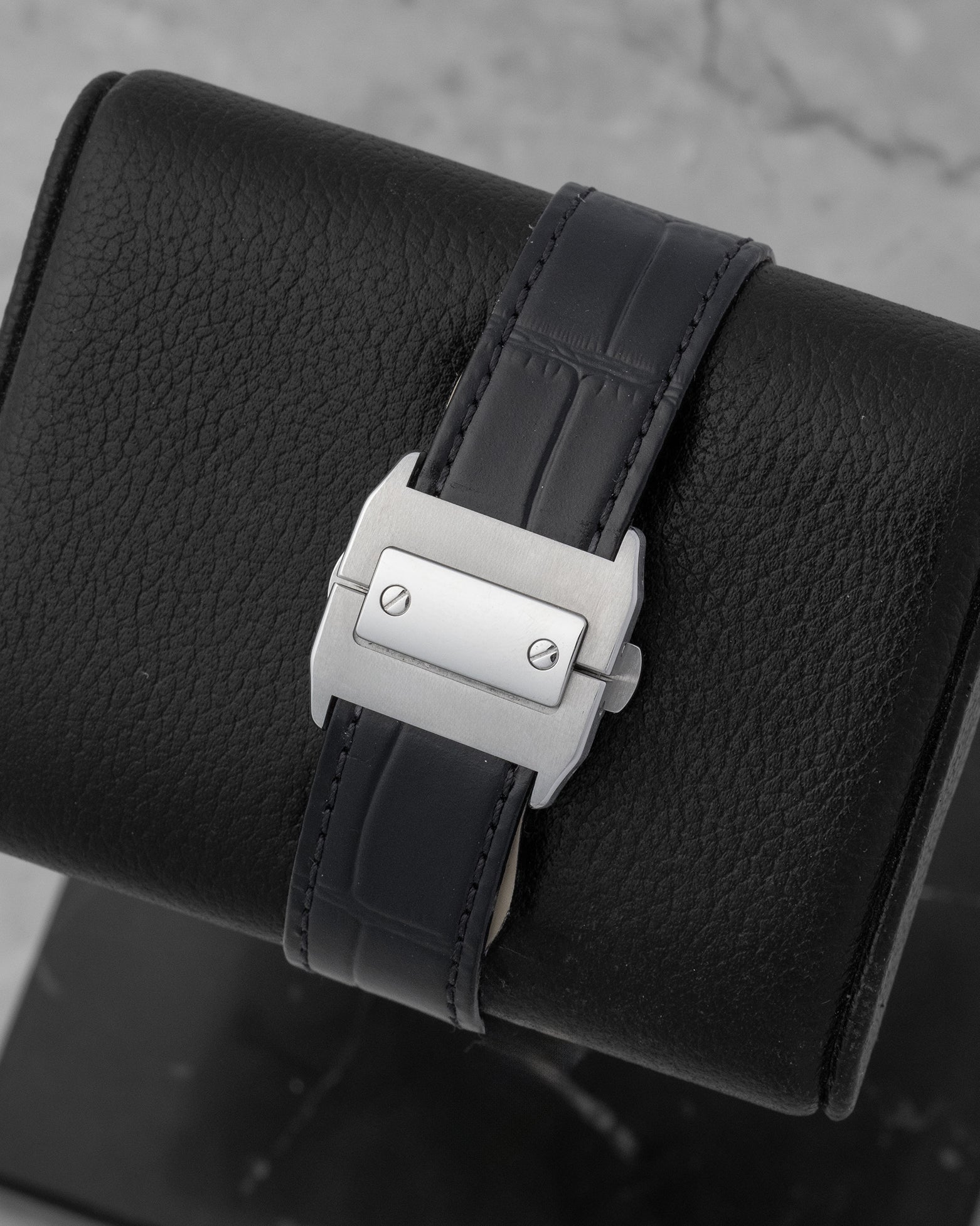 heavy, industrial satin-brushed stainless steel double folding deployment clasp on a black alligator leather Cartier watch strap