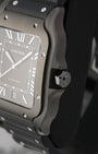 Side profile focus on the satin-brushed steel case architecture and the heptagonal winding crown set with a faceted black synthetic spinel