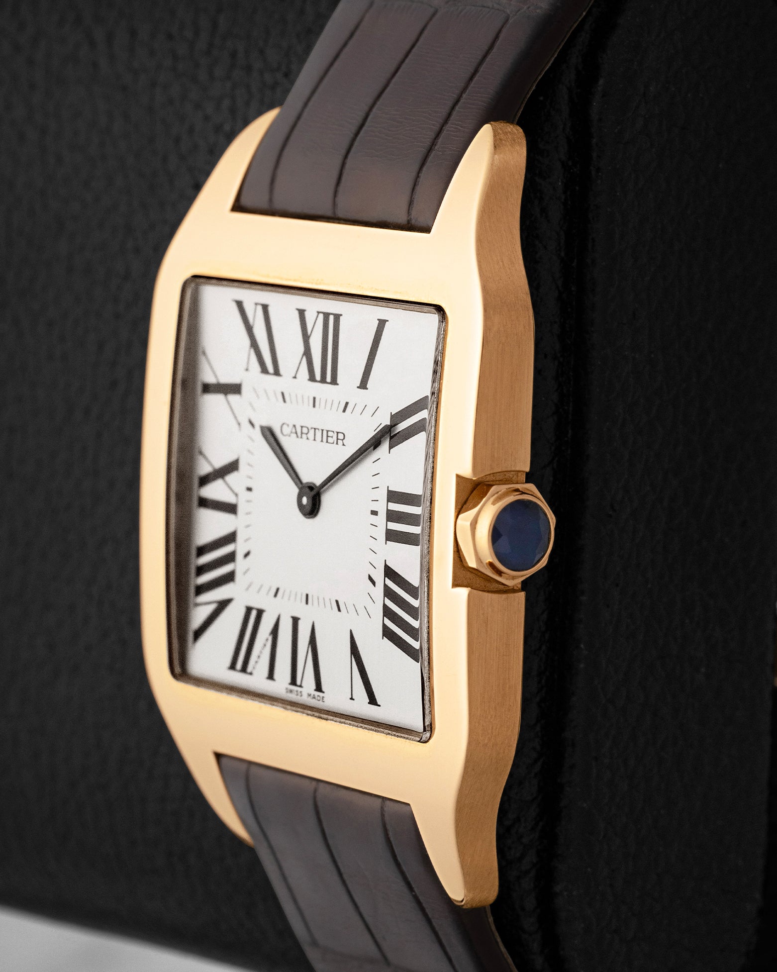 Side profile view displaying the beaded 18k rose gold crown set with a blue sapphire cabochon on Cartier Santos-Dumont W2006951
