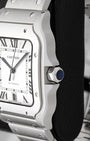 Profile view showing the 7-sided crown set with a blue synthetic spinel cabochon on a Cartier Santos WSSA0018
