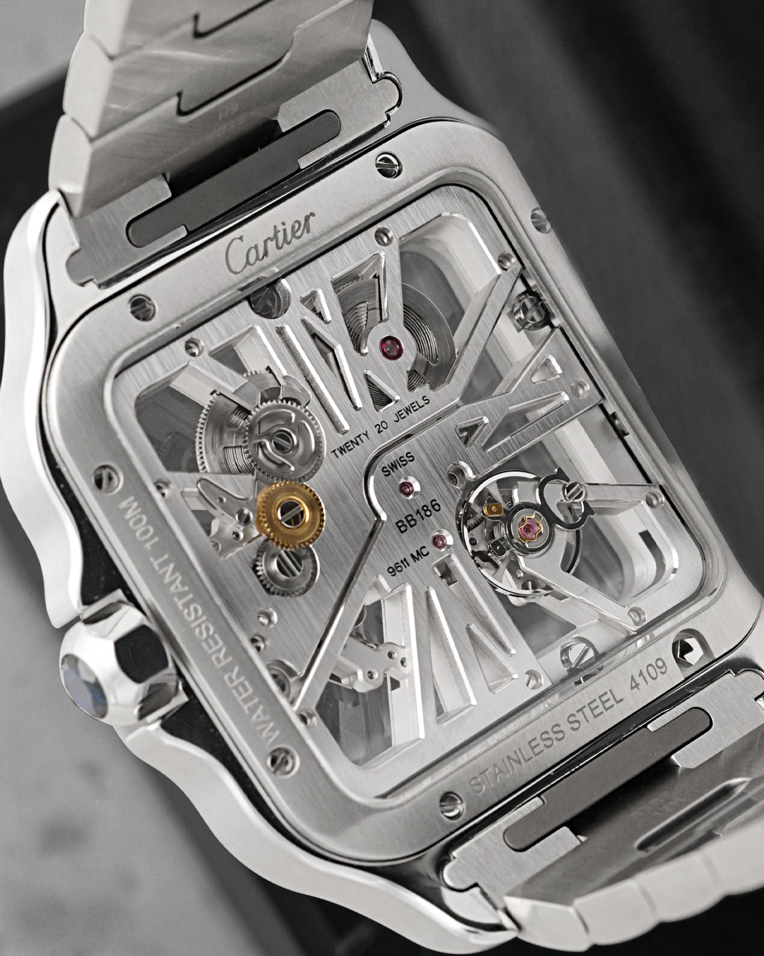 Exhibition sapphire case back view showcasing the manual-wind Calibre 9611 MC movement on a Cartier Santos Skeleton WHSA0015