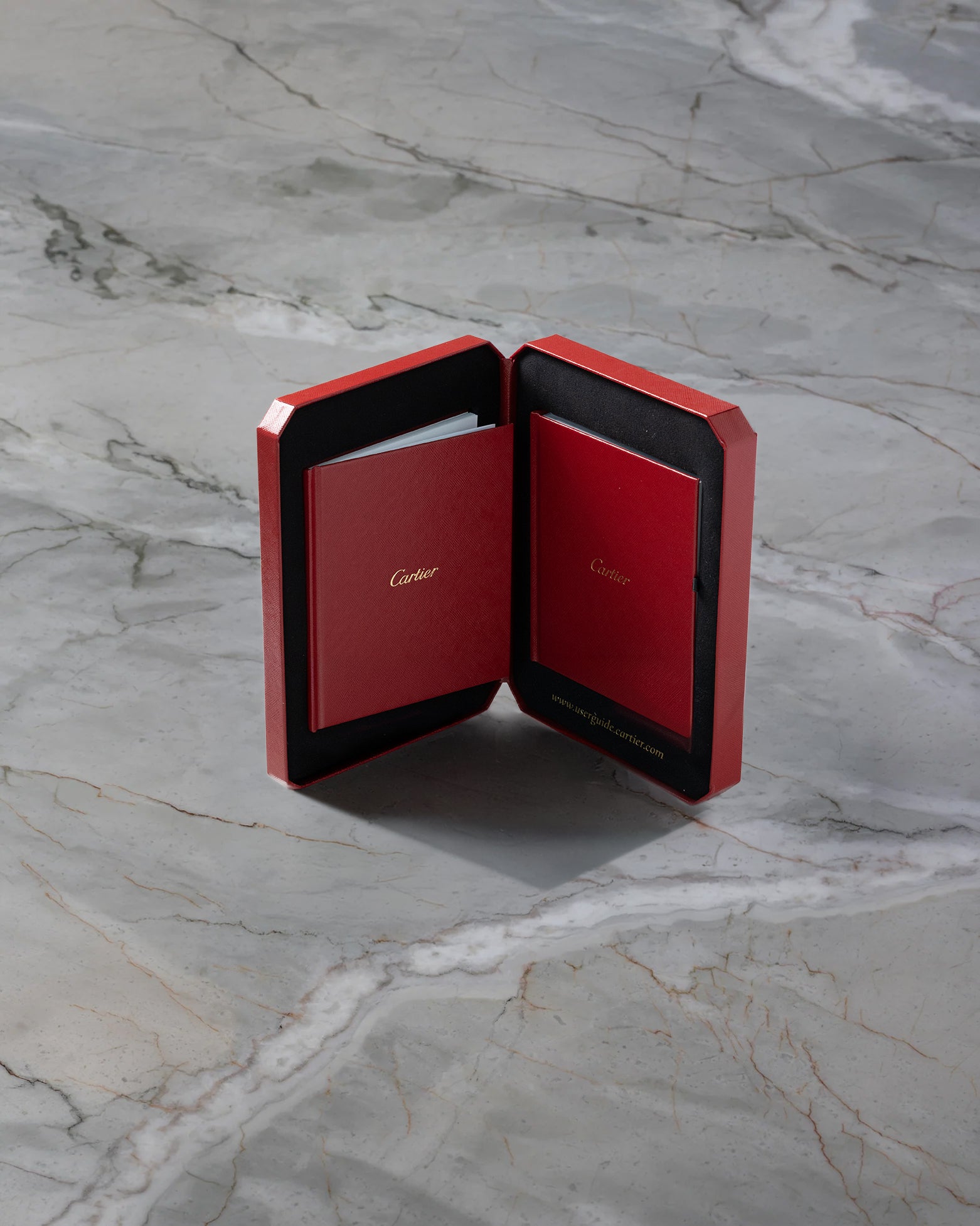 Open red Cartier luxury watch travel pouch included with the pre-owned 2022 Cartier Santos Skeleton