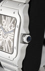 Close-up of the sapphire-set heptagonal crown and stainless steel case edge on a Cartier Santos Skeleton WHSA0015
