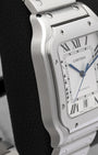 Left side profile view displaying the ergonomic curved stainless steel case and bezel screws of Cartier Santos de Cartier WSSA0018