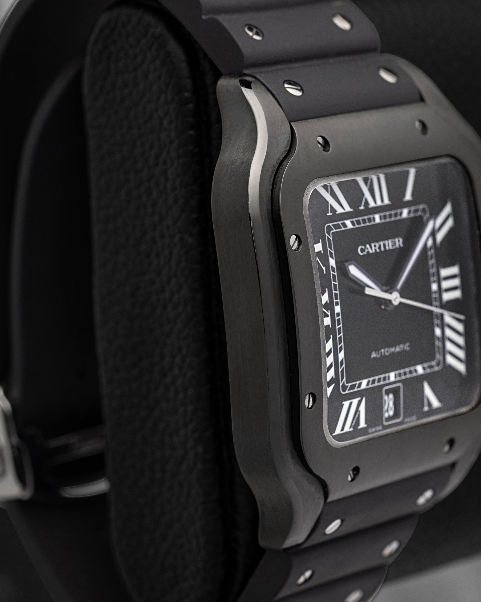 Left side profile view displaying the black ADLC steel case and bezel screws of Cartier Santos de Cartier WSSA0039