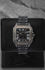 Front view of a pre-owned Cartier Santos de Cartier Large Model Ref WSSA0039 featuring a steel case, black ADLC bezel, and matching black dial, available at Noah's Fine Watches and Jewelry Dallas