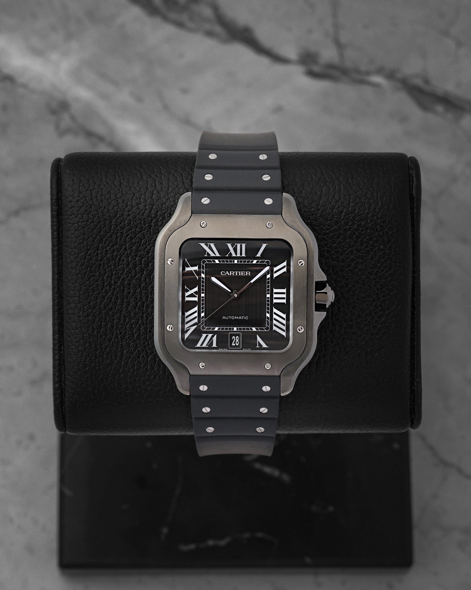 Front view of a pre-owned Cartier Santos de Cartier Large Model Ref WSSA0039 featuring a steel case, black ADLC bezel, and matching black dial, available at Noah's Fine Watches and Jewelry Dallas