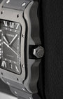 Side profile view showing the black synthetic spinel-set crown and black ADLC stainless steel case of Cartier Santos WSSA0039
