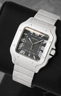 front view of Cartier Santos WSSA0096 highlighting the black dial, luminous Roman numerals, and steel bracelet