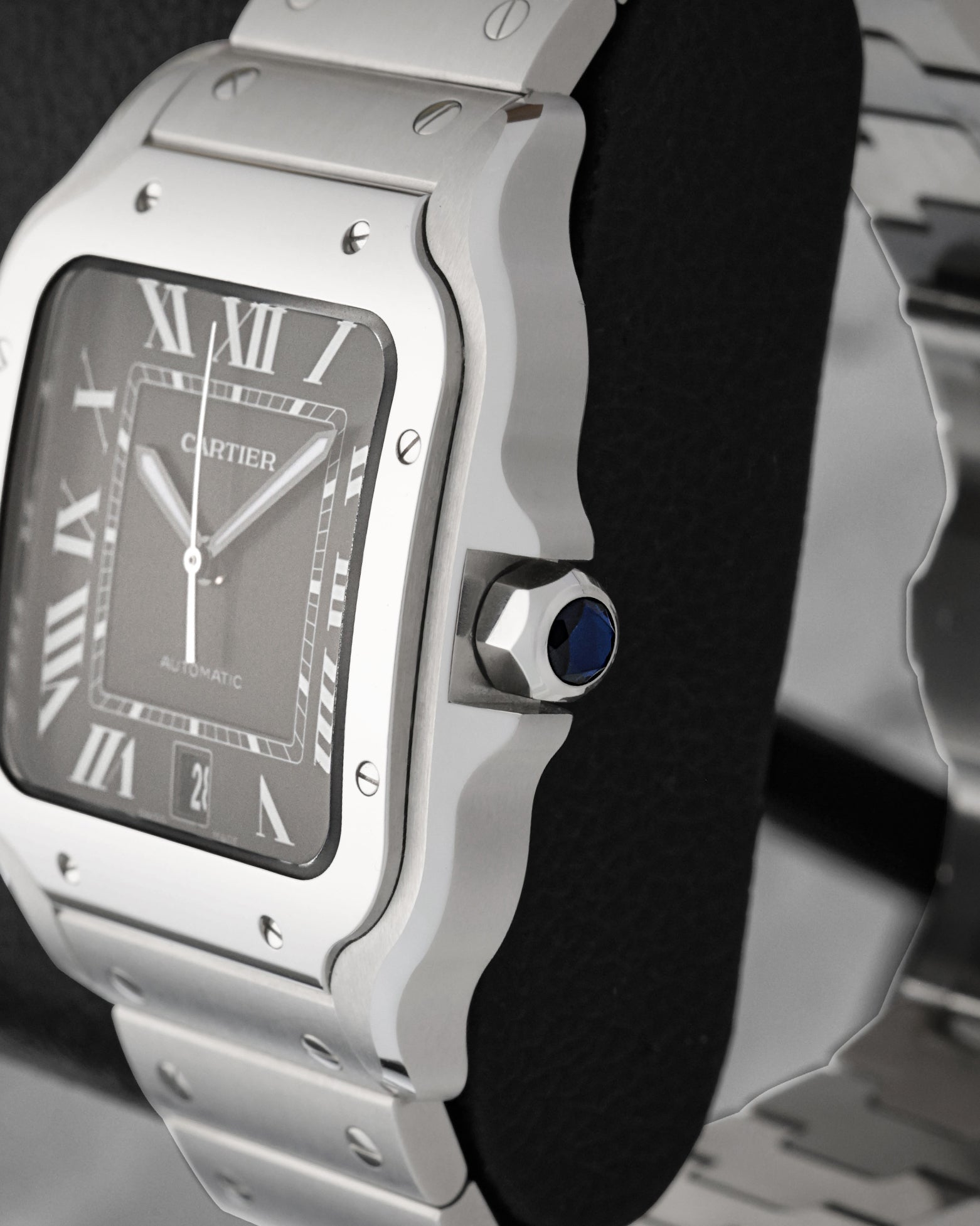 Close-up of seven-sided crown set with blue synthetic spinel on a Cartier Santos WSSA0096 stainless steel case